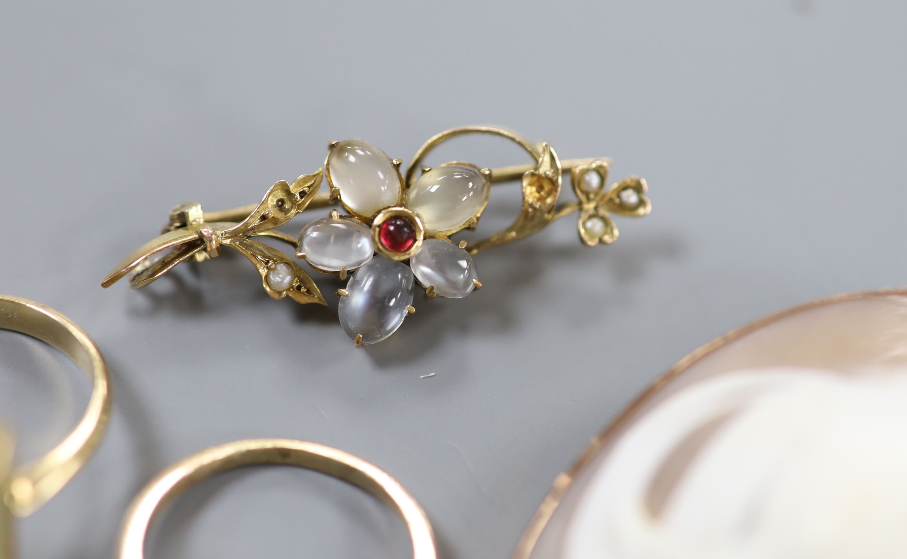 A 9ct gold and citrine set ring, two other gem set rings, a 9ct mounted cameo brooch, a yellow metal and gem set bar brooch and a pair of 9ct gold and gem set drop earrings.